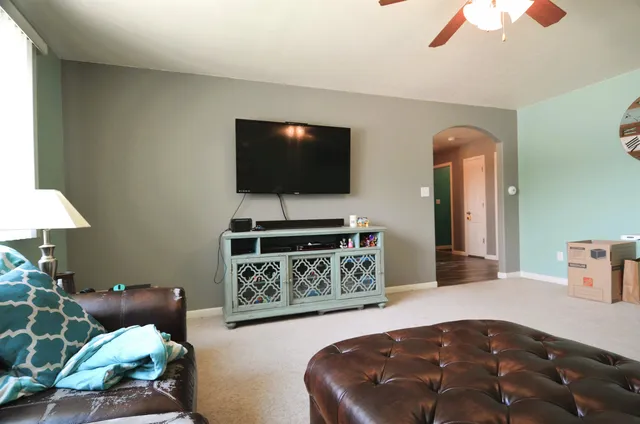 a living room with furniture and a chandelier
