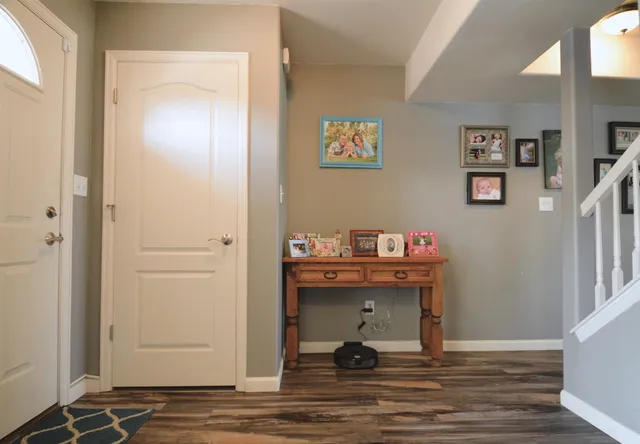 an empty room with wooden floor and a window