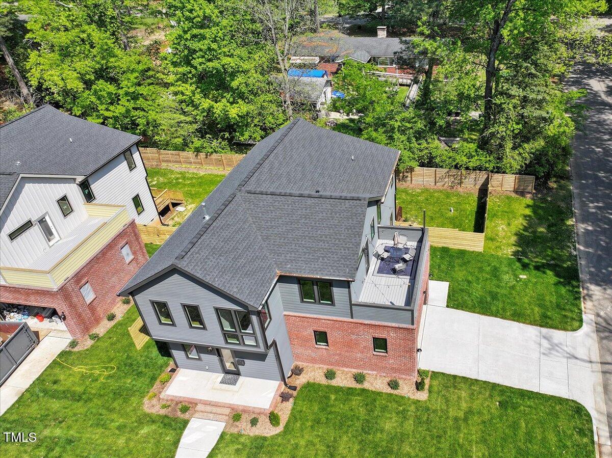 an aerial view of a house with swimming pool garden and patio