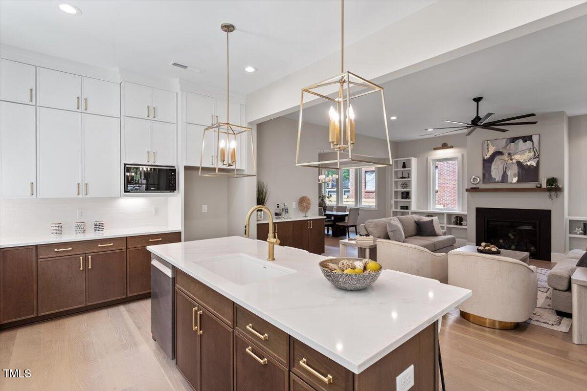 337 Merrywood Drive Raleigh, NC 27610 - Photo 17 of 52 a kitchen with a sink a counter space appliances and cabinets