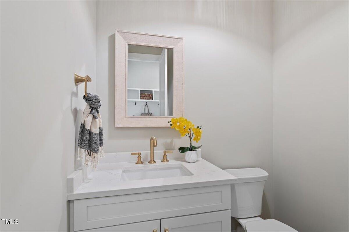 337 Merrywood Drive Raleigh, NC 27610 - Photo 20 of 52 a bathroom with a sink vanity and mirror