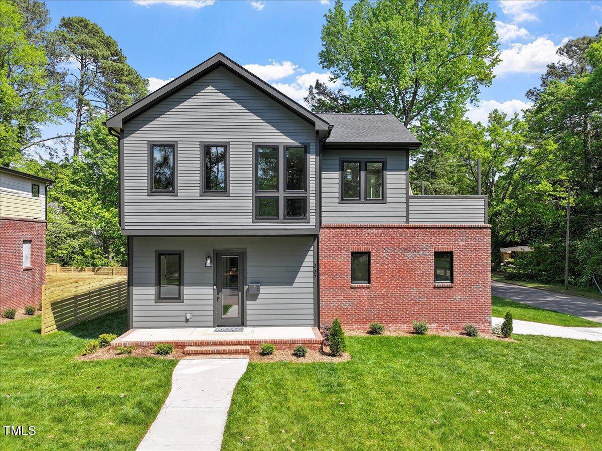 337 Merrywood Drive Raleigh, NC 27610 - Photo 2 of 52 a front view of a house with a yard and trees