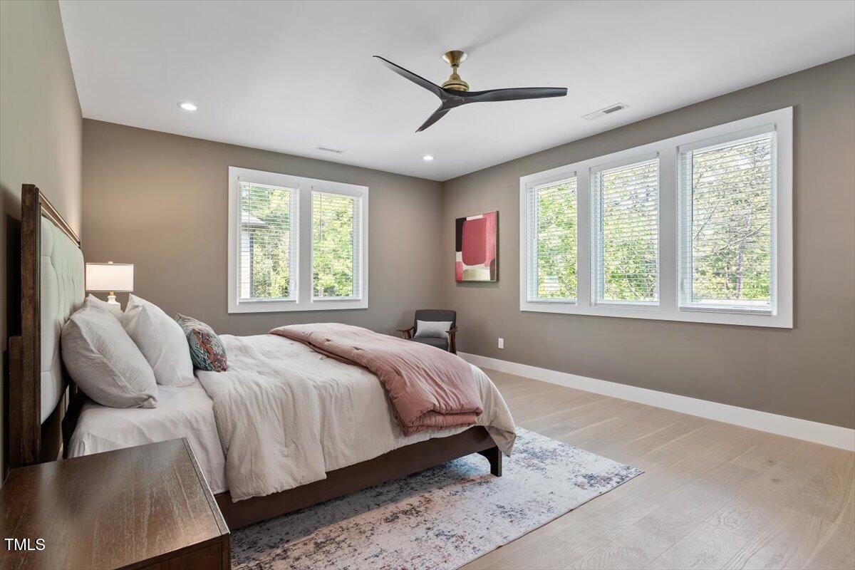 337 Merrywood Drive Raleigh, NC 27610 - Photo 21 of 52 a bedroom with a bed and a large window