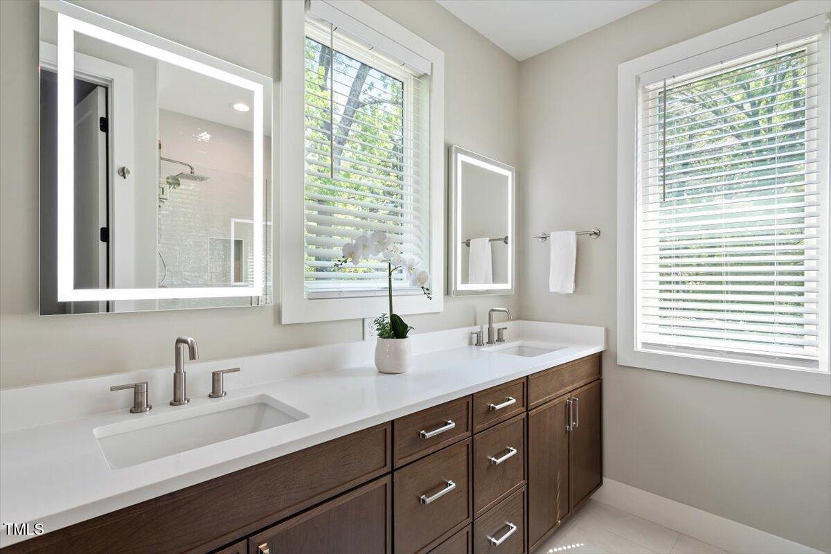 337 Merrywood Drive Raleigh, NC 27610 - Photo 23 of 52 a bathroom with a sink double vanity and a window
