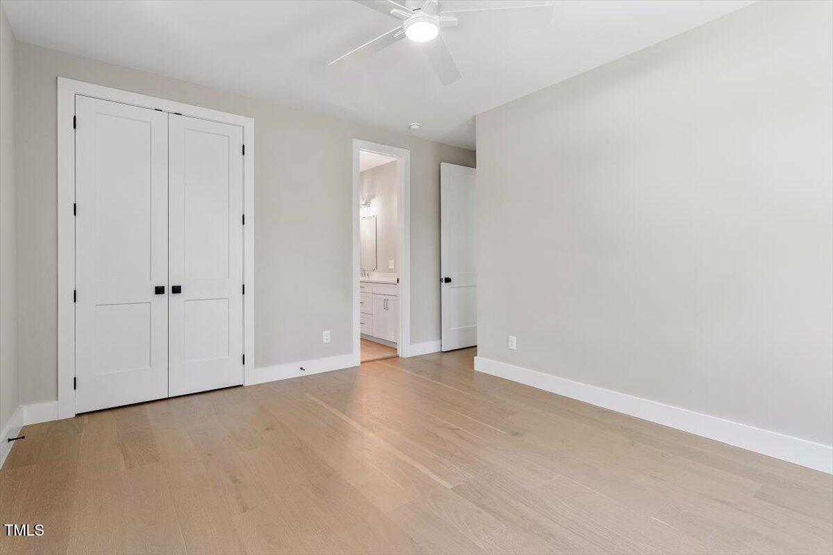 337 Merrywood Drive Raleigh, NC 27610 - Photo 29 of 52 a view of an empty room with a ceiling fan