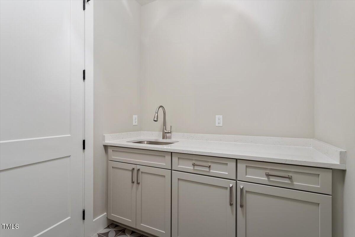 337 Merrywood Drive Raleigh, NC 27610 - Photo 31 of 52 a sink with white cabinets