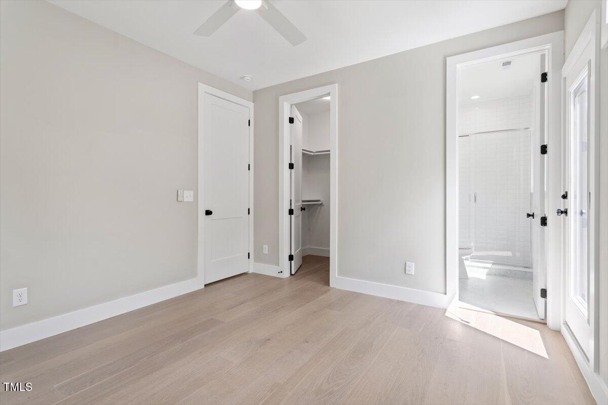 337 Merrywood Drive Raleigh, NC 27610 - Photo 34 of 52 a view of an empty room with wooden floor and a bathroom