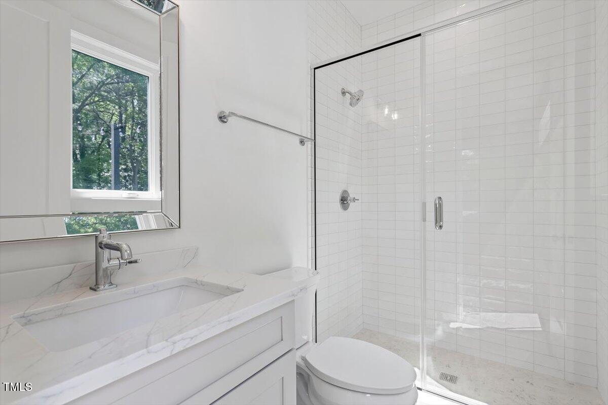 337 Merrywood Drive Raleigh, NC 27610 - Photo 35 of 52 a bathroom with a sink a toilet and shower