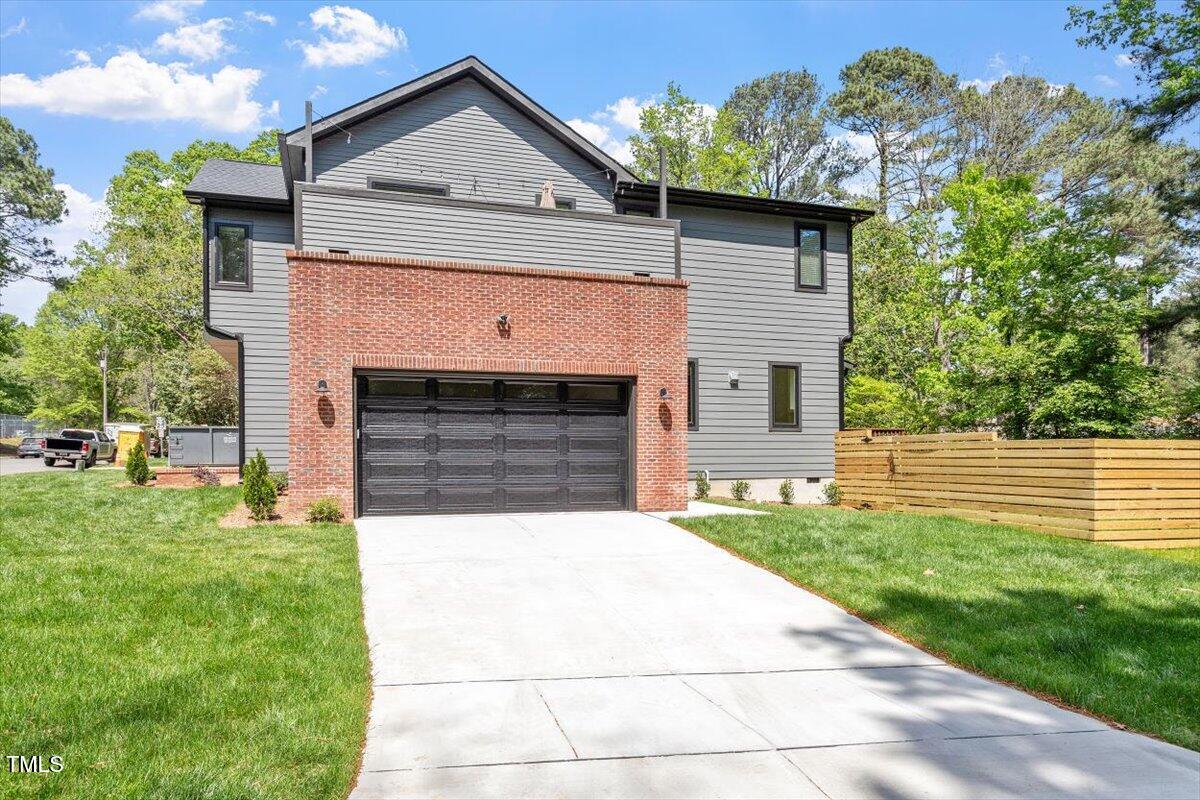 337 Merrywood Drive Raleigh, NC 27610 - Photo 39 of 52 a front view of a house with a yard and garage