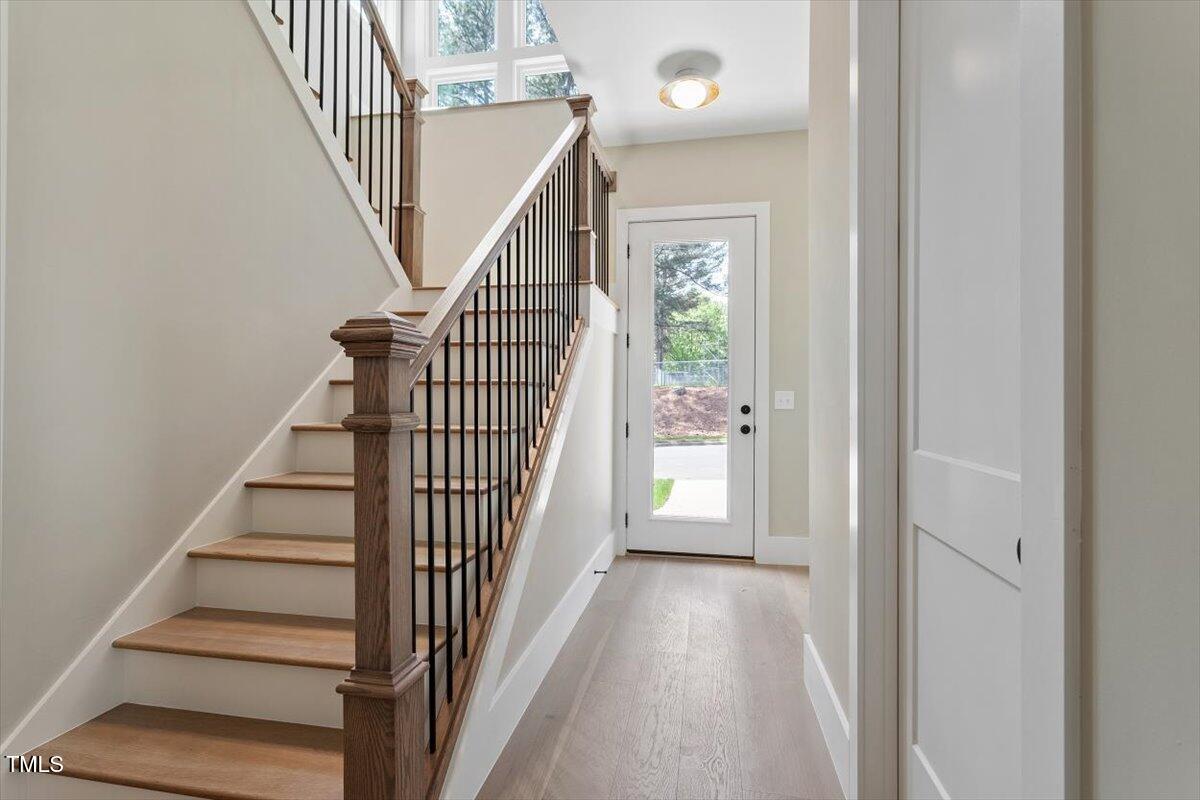 337 Merrywood Drive Raleigh, NC 27610 - Photo 4 of 52 a view of a hallway with wooden floor and entryway
