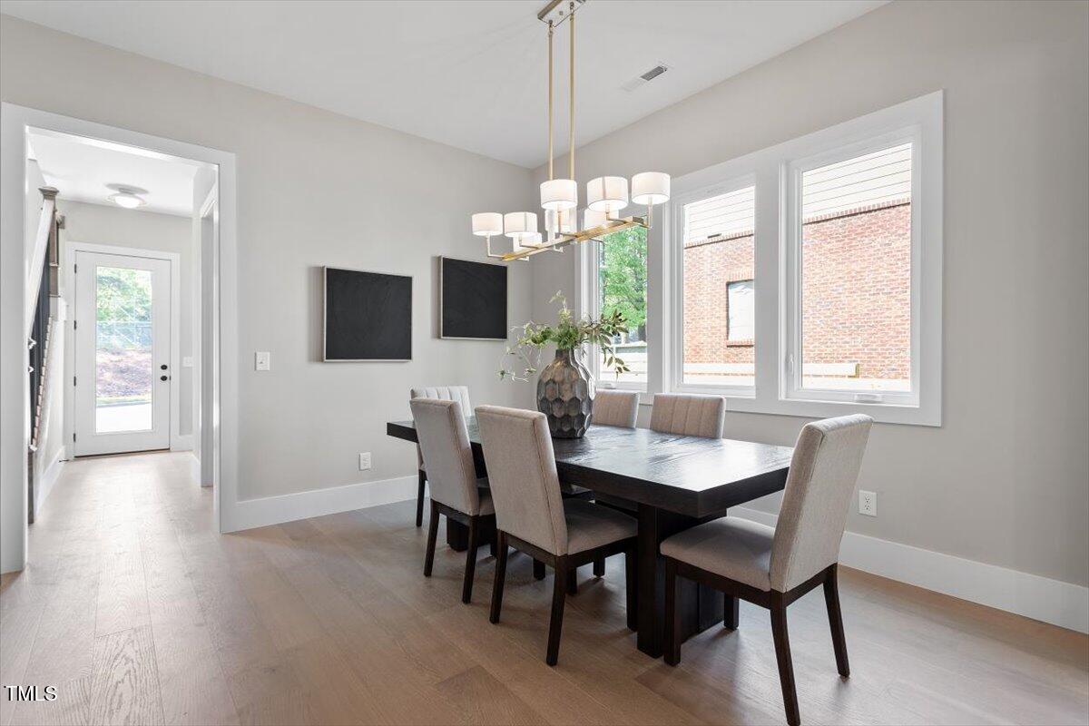 337 Merrywood Drive Raleigh, NC 27610 - Photo 6 of 52 a view of a dining room with furniture window and wooden floor