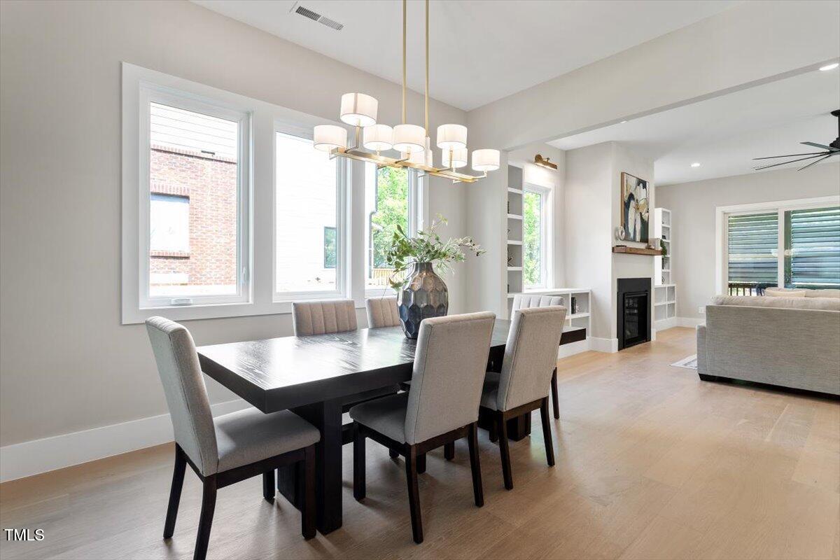 337 Merrywood Drive Raleigh, NC 27610 - Photo 7 of 52 a dining room with furniture a chandelier and window