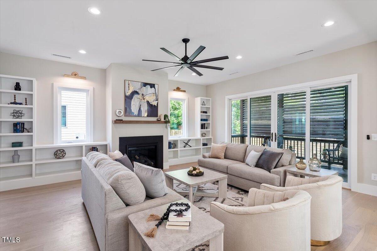 337 Merrywood Drive Raleigh, NC 27610 - Photo 10 of 52 a living room with furniture a fireplace and a large window