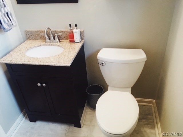 9717 Kingman Road Chesterfield, VA 23236 - Photo 11 of 13 a bathroom with a toilet sink and mirror