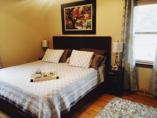 9717 Kingman Road Chesterfield, VA 23236 - Photo 12 of 13 a bedroom with a bed and wooden floor