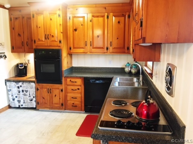 9717 Kingman Road Chesterfield, VA 23236 - Photo 5 of 13 a kitchen with stainless steel appliances granite countertop a stove a sink and a microwave