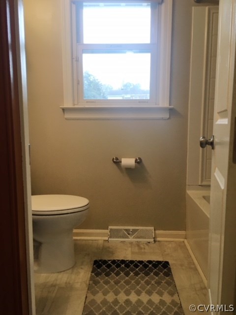 9717 Kingman Road Chesterfield, VA 23236 - Photo 8 of 13 a bathroom with a toilet and a window