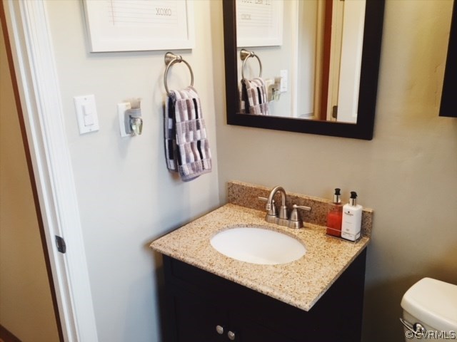 9717 Kingman Road Chesterfield, VA 23236 - Photo 10 of 13 a bathroom with a granite countertop sink and a mirror