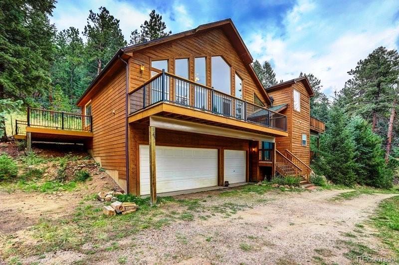 32697 Little Cub Road Evergreen, CO 80439 - Photo 4 of 40 a front view of a house with a yard