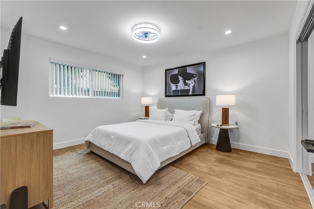 4354 Oakwood Avenue Los Angeles, CA 90004 - Photo 13 of 17 a bedroom with a bed and a flat screen tv