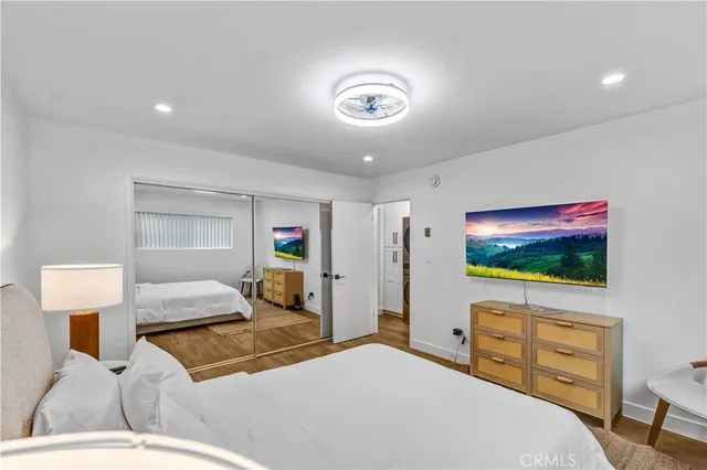 a bedroom with a bed and a flat screen tv