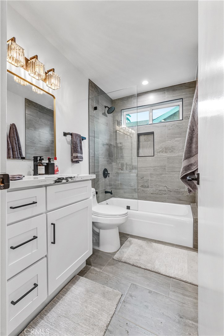 4354 Oakwood Avenue Los Angeles, CA 90004 - Photo 15 of 17 a bathroom with a double vanity sink toilet bathtub and mirror