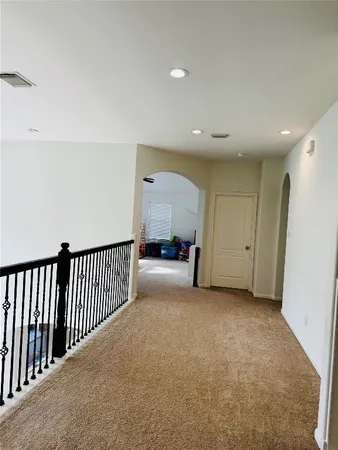 a living room with furniture floor to ceiling window and a potted plant