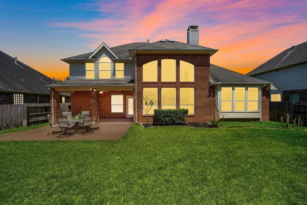 a living room with a couch and a dining table with wooden floor