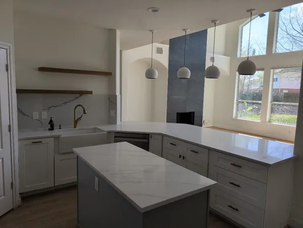 a spacious bedroom with a bed and wooden floor