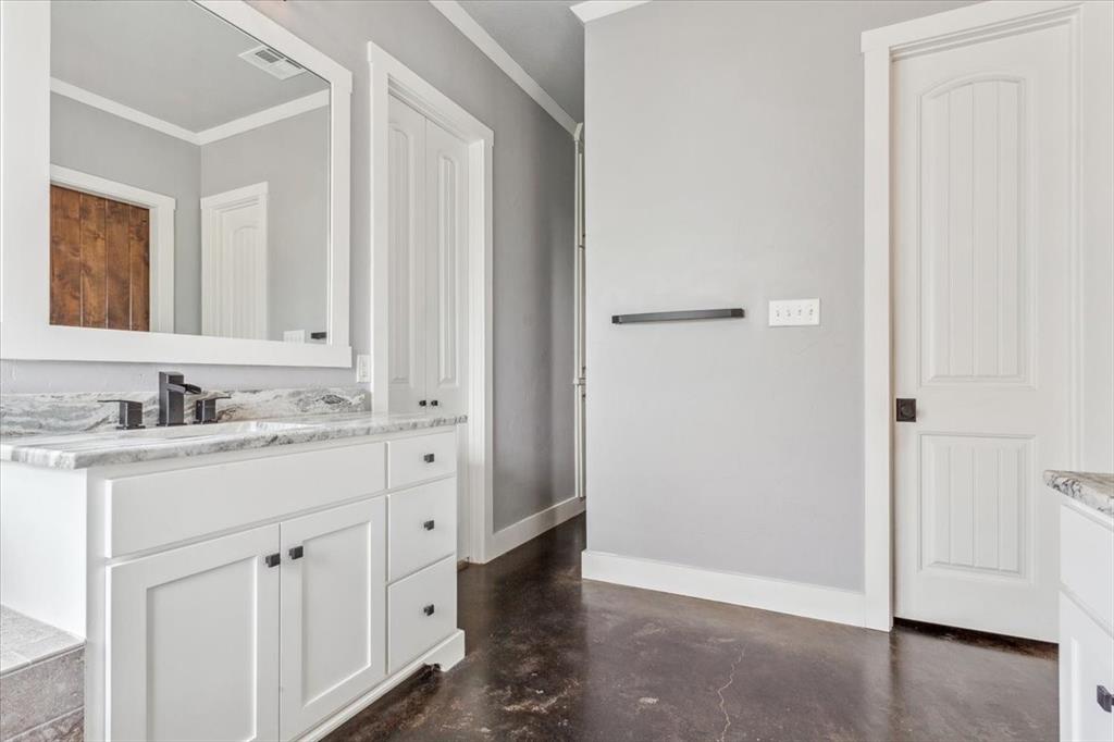 259 County Road 149 Riesel, TX 76682 - Photo 19 of 40 Bathroom with concrete flooring, crown molding, baseboards, and vanity