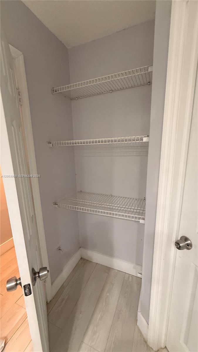 821 Lyons Road, Unit 21102 Coconut Creek, FL 33063 - Photo 4 of 17 a view of a room with racks on the wall