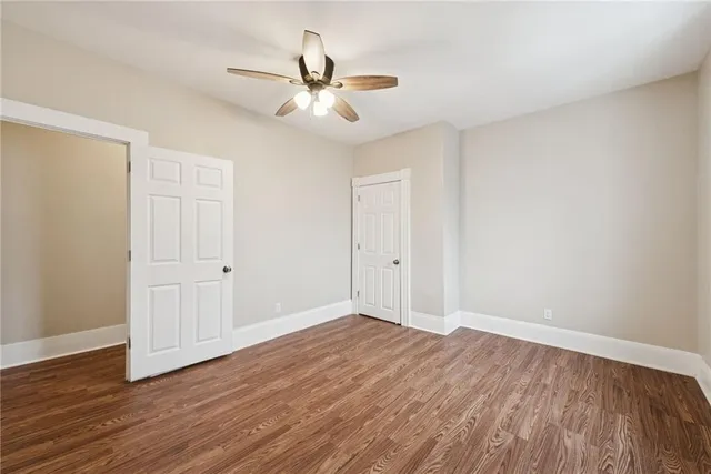a view of an empty room with wooden floor