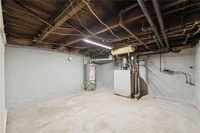 a view of white house with a yard covered in snow