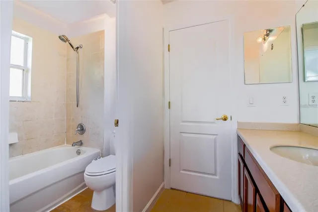 a bathroom with a sink toilet vanity and tub