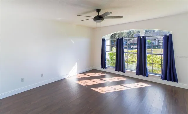 wooden floor in an empty room with a window