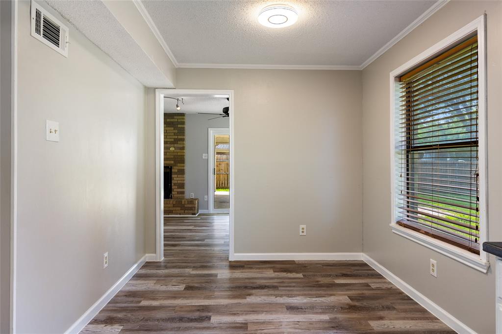 2820 Bois D'Arc Street Commerce, TX 75428 - Photo 16 of 40 a view of wooden floor and windows in a room