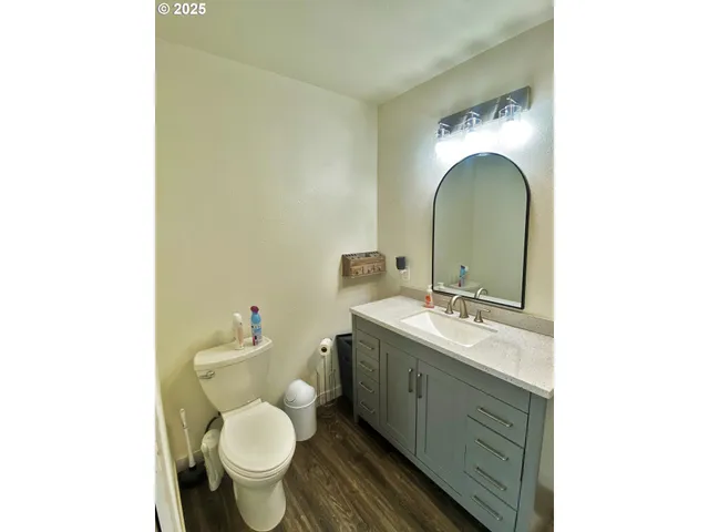 a bathroom with a toilet sink and mirror