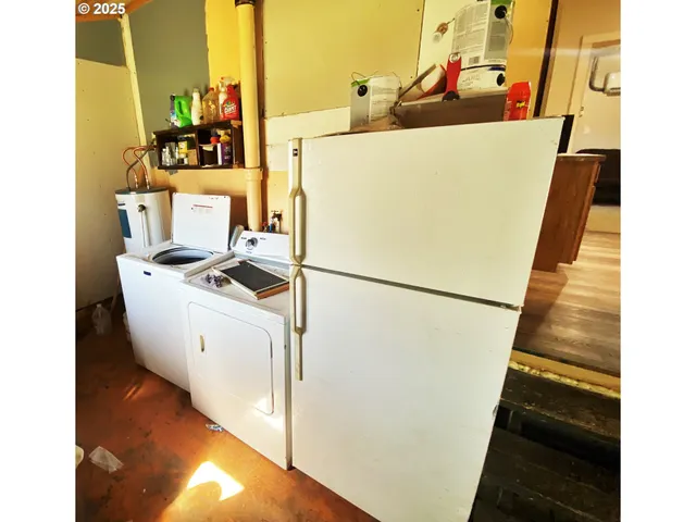 a white refrigerator freezer sitting next to a white wall