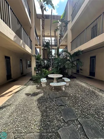 a backyard of a house with yard and outdoor seating