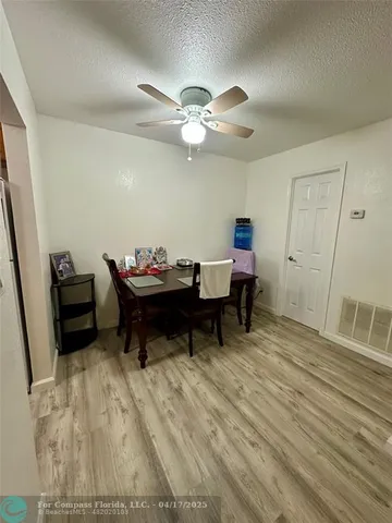 a reading room with wooden floor and furniture