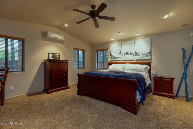 a spacious bedroom with a bed and dresser
