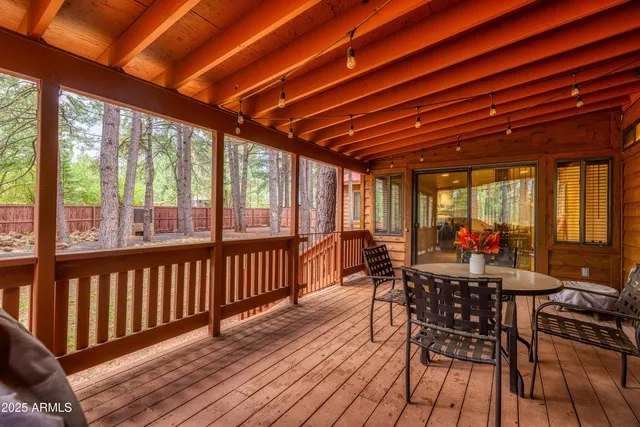 a view of a patio with table and chairs and wooden floor