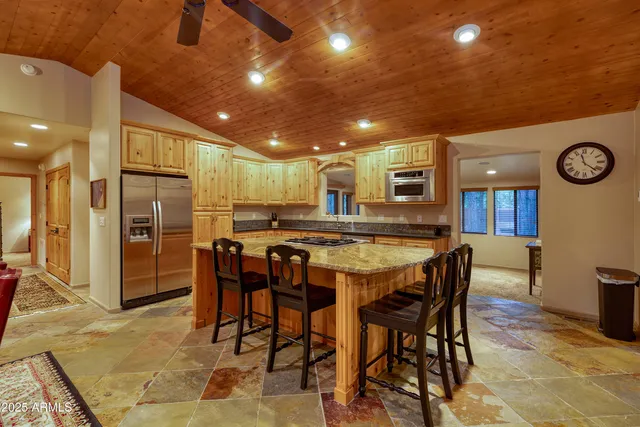 a large kitchen with a table and chairs