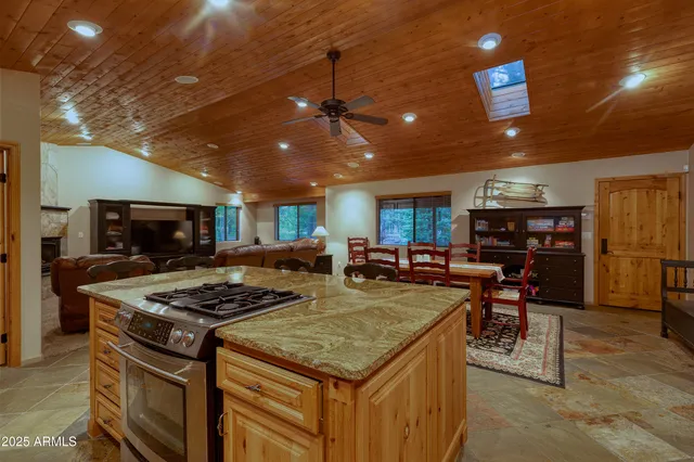 a kitchen with stainless steel appliances granite countertop a stove and a refrigerator