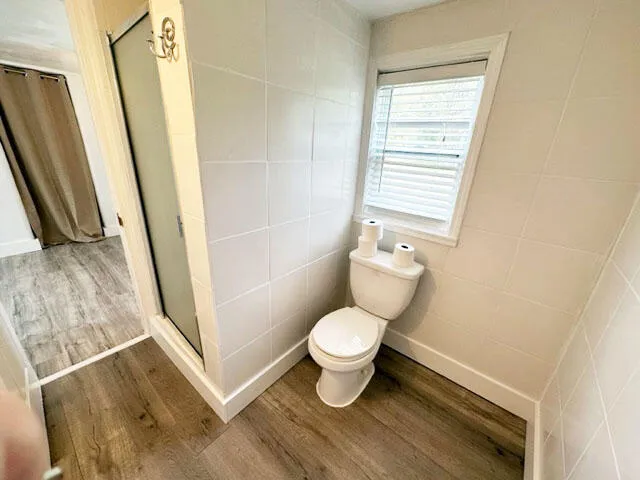 a bathroom with a toilet and a shower