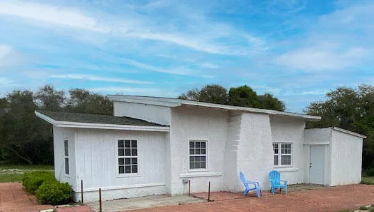 a view of a house with a backyard