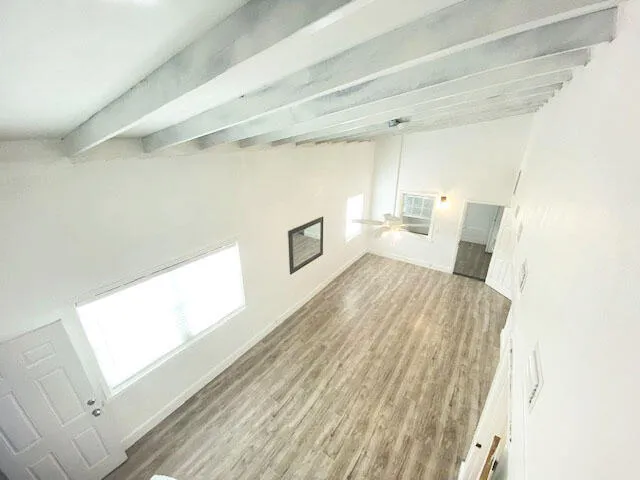 a spacious bedroom with a bed and a window