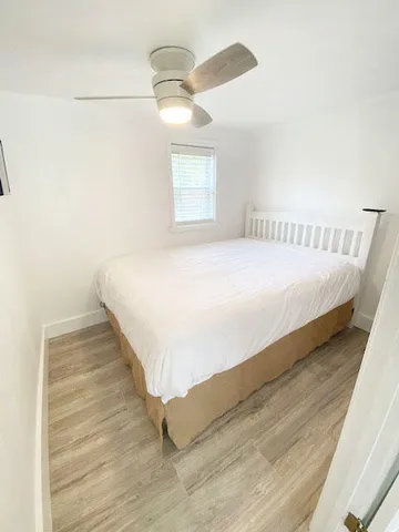 a bed sitting in a bedroom next to a window