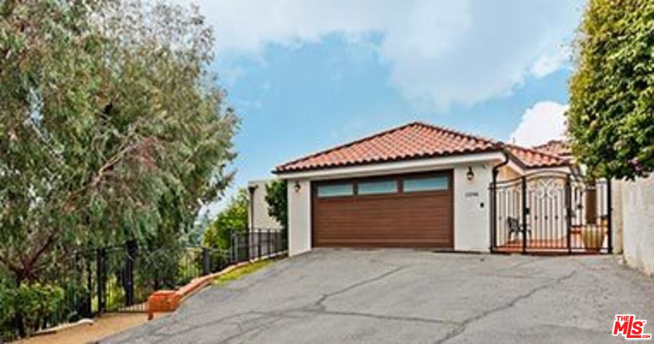 13146 Rivers Road Los Angeles, CA 90049 - Photo 1 of 38 a front view of a house with a garage