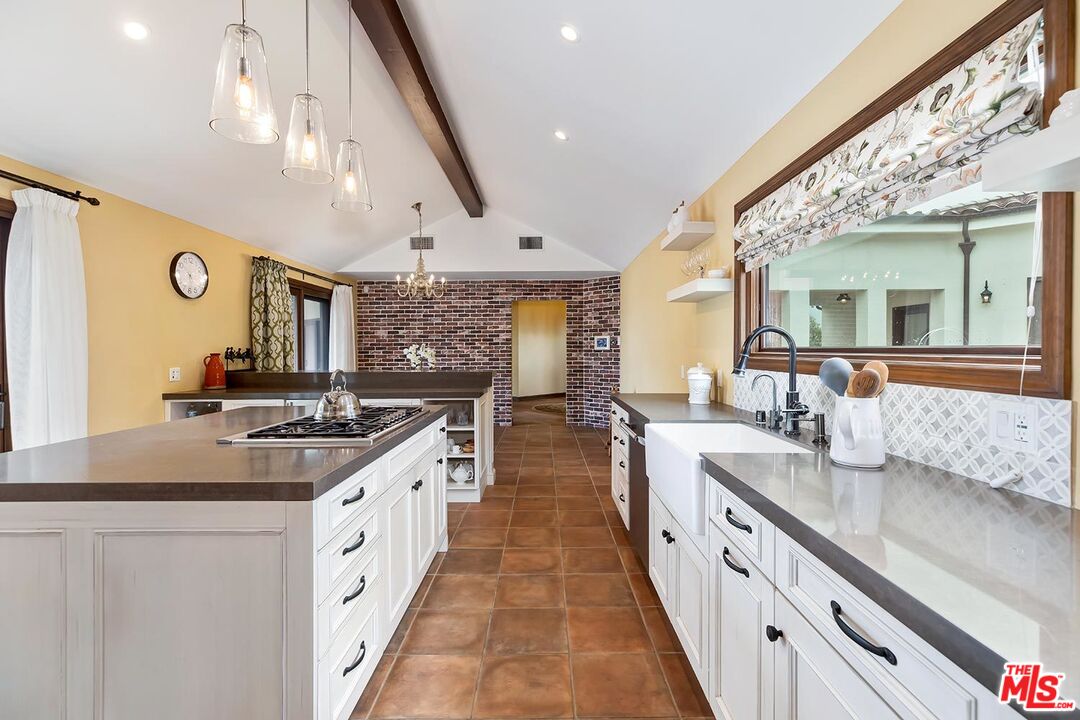 13146 Rivers Road Los Angeles, CA 90049 - Photo 11 of 38 a large kitchen with stainless steel appliances a sink and cabinets